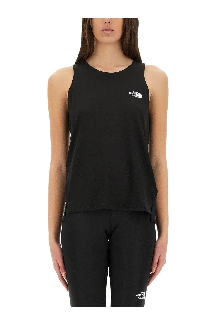 The north face women’s black sleeveless tank top features a white logo on the chest made from lightweight material