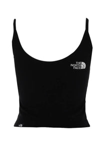 The North Face women’s slim crop top in black with thin straps and a white logo on the chest