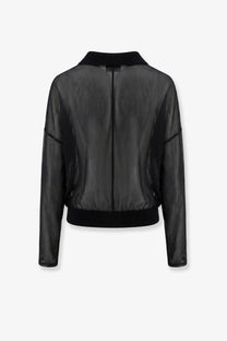 Black sheer bomber jacket with solid black collar and cuffs paired with nude women’s cotton blend polo shirt black