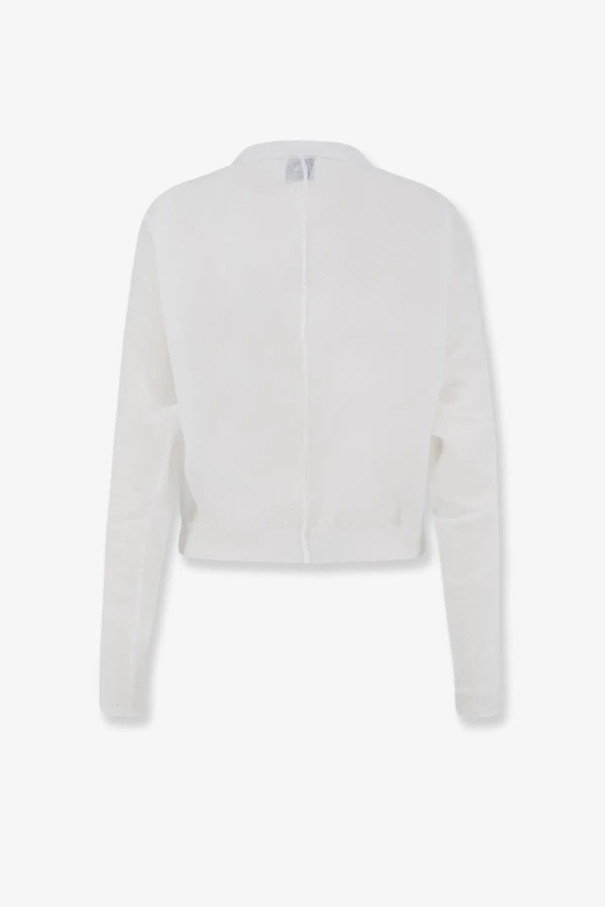 White cropped knit cardigan with long sleeves and central zipper paired with nude cotton blend polo shirt white
