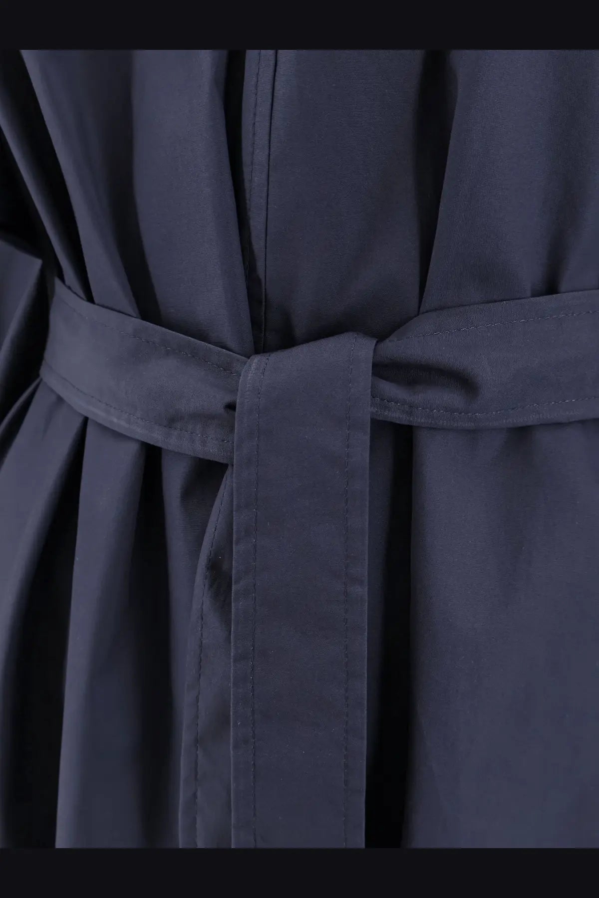 Dark navy belted cotton coat with matching fabric belt tied in a neat knot for women’s outerwear