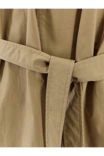 Beige trench coat belt with neat stitching and tied knot paired with nude women’s cotton dress green