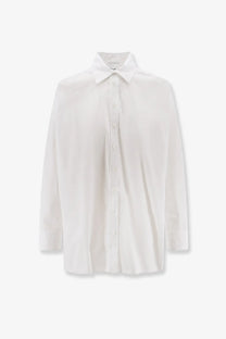 Nude women’s white cotton shirt with minimalist design, crisp collar, long sleeves, and lightweight fabric