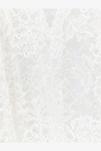 Nude womens white lace shirt featuring delicate white floral lace fabric with intricate patterns
