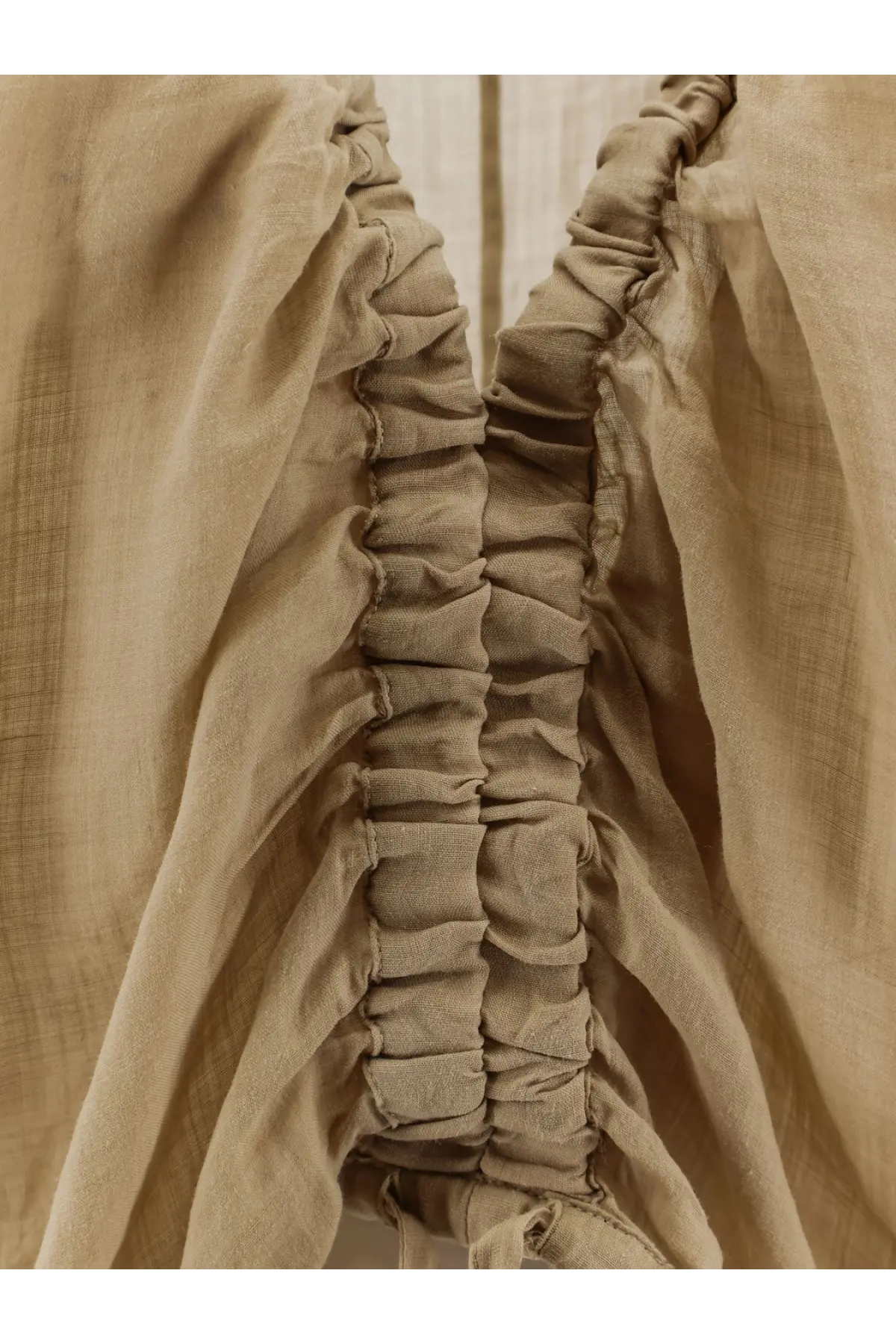 Nude women’s linen blend shirt in beige with gathered ruching along the side seam