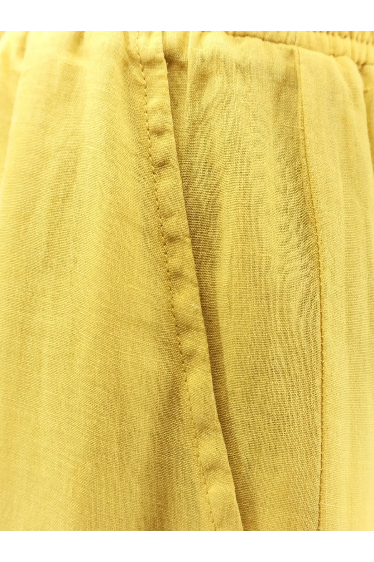 Nude women’s linen blend trousers cedar in yellow with relaxed fit slightly wrinkled texture and visible seam stitching
