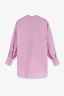 A soft pink oversized cotton button-up shirt for women with long sleeves and relaxed fit