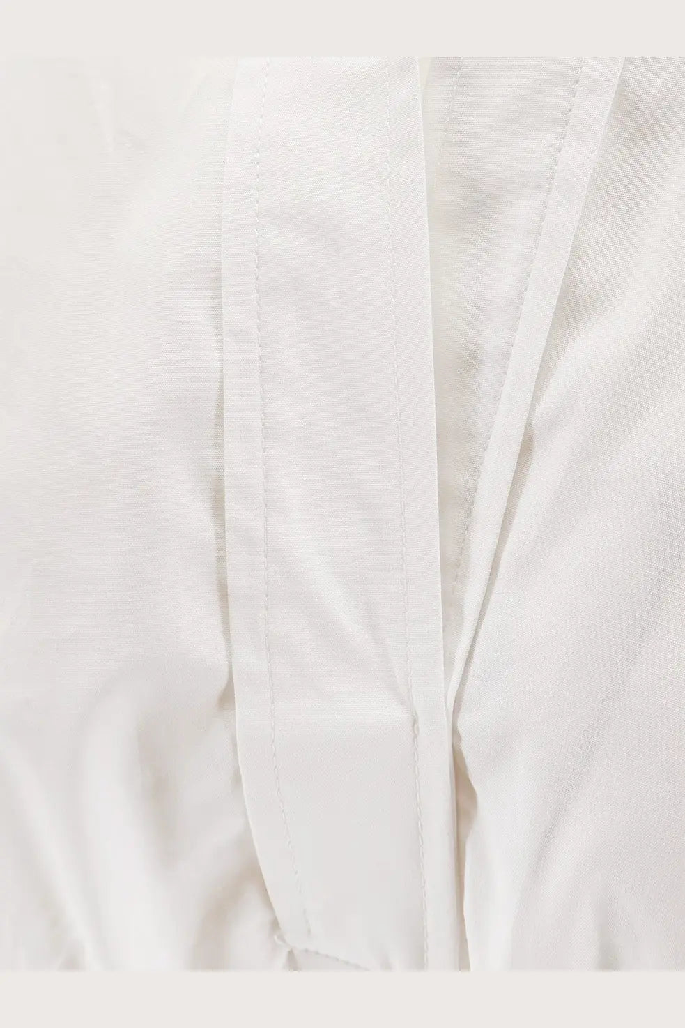 Nude women’s polo cotton dress white showing white cotton fabric with neat straight stitching along the seams