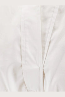 Nude women’s polo cotton dress white showing white cotton fabric with neat straight stitching along the seams
