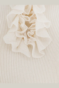 A delicate off-white ruffled detail on a nude women’s ribbed cotton blend sweater in white