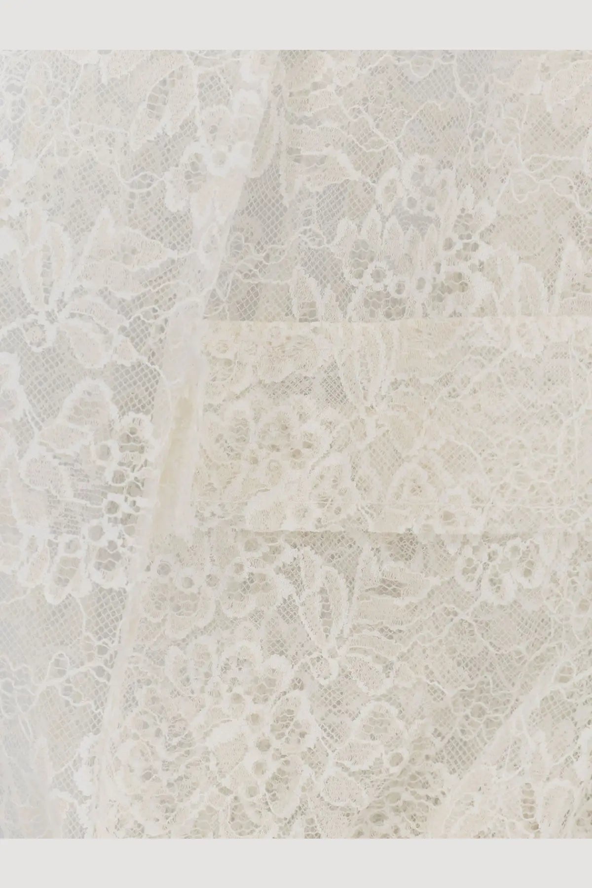Nude women’s sleeveless lace jacket in white featuring delicate ivory lace fabric with intricate floral patterns and sheer texture