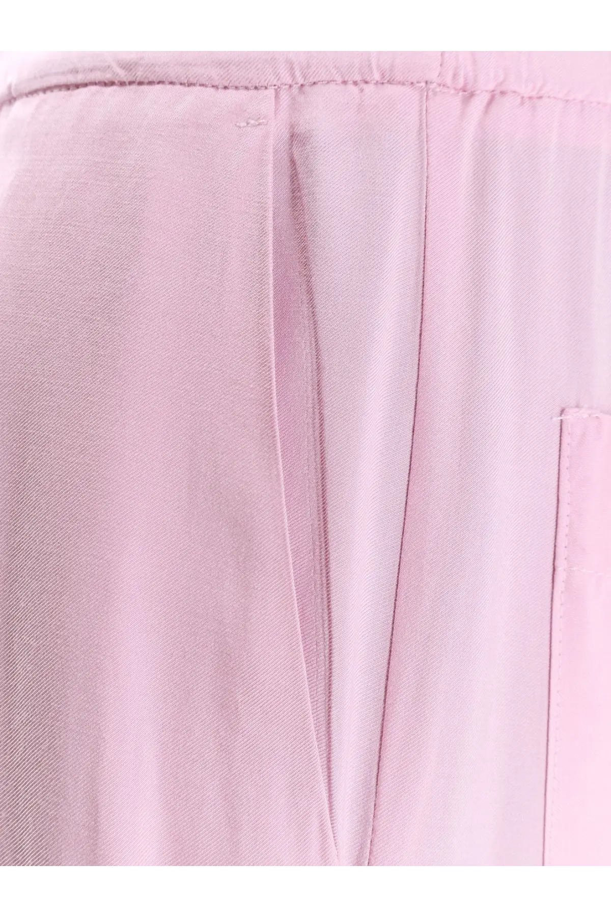 Soft pink woven viscose trousers for women with subtle texture and clean stitching in nude pink color
