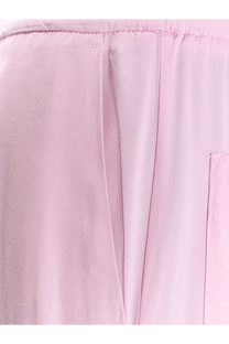 Soft pink woven viscose trousers for women with subtle texture and clean stitching in nude pink color