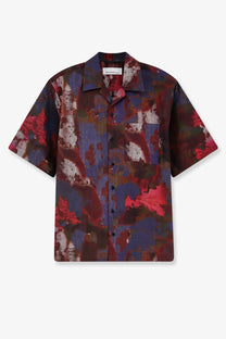 Oamc Peacemaker men’s boxy short-sleeved cotton shirt with bold abstract red blue and dark purple camouflage pattern