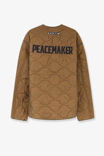 Back view of oamc peacemaker men’s beige quilted nylon combat liner jacket with bold black peacemaker lettering