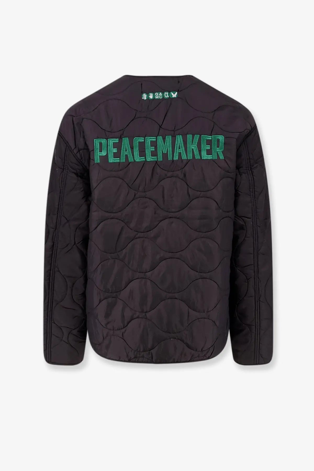Back view of oamc peacemaker men’s black quilted compact liner jacket with green embroidered peacemaker lettering