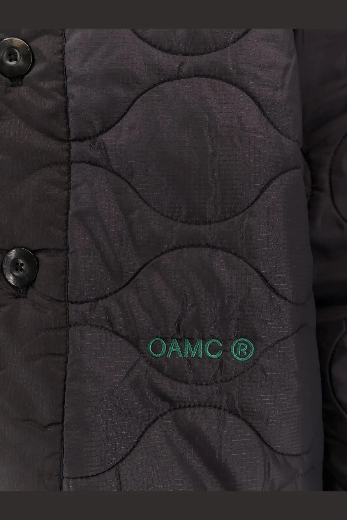 Black oamc peacemaker men’s quilted jacket with wavy stitching and green oamc embroidery