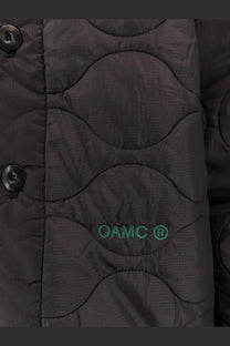 Black oamc peacemaker men’s quilted jacket with wavy stitching and green oamc embroidery