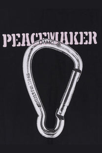 Silver metal carabiner with damc branding and weight rating engraved shown with oamc peacemaker men’s black cotton shirt