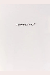 Black peacemaker logo text on the white oamc peacemaker men’s cotton shirt front design