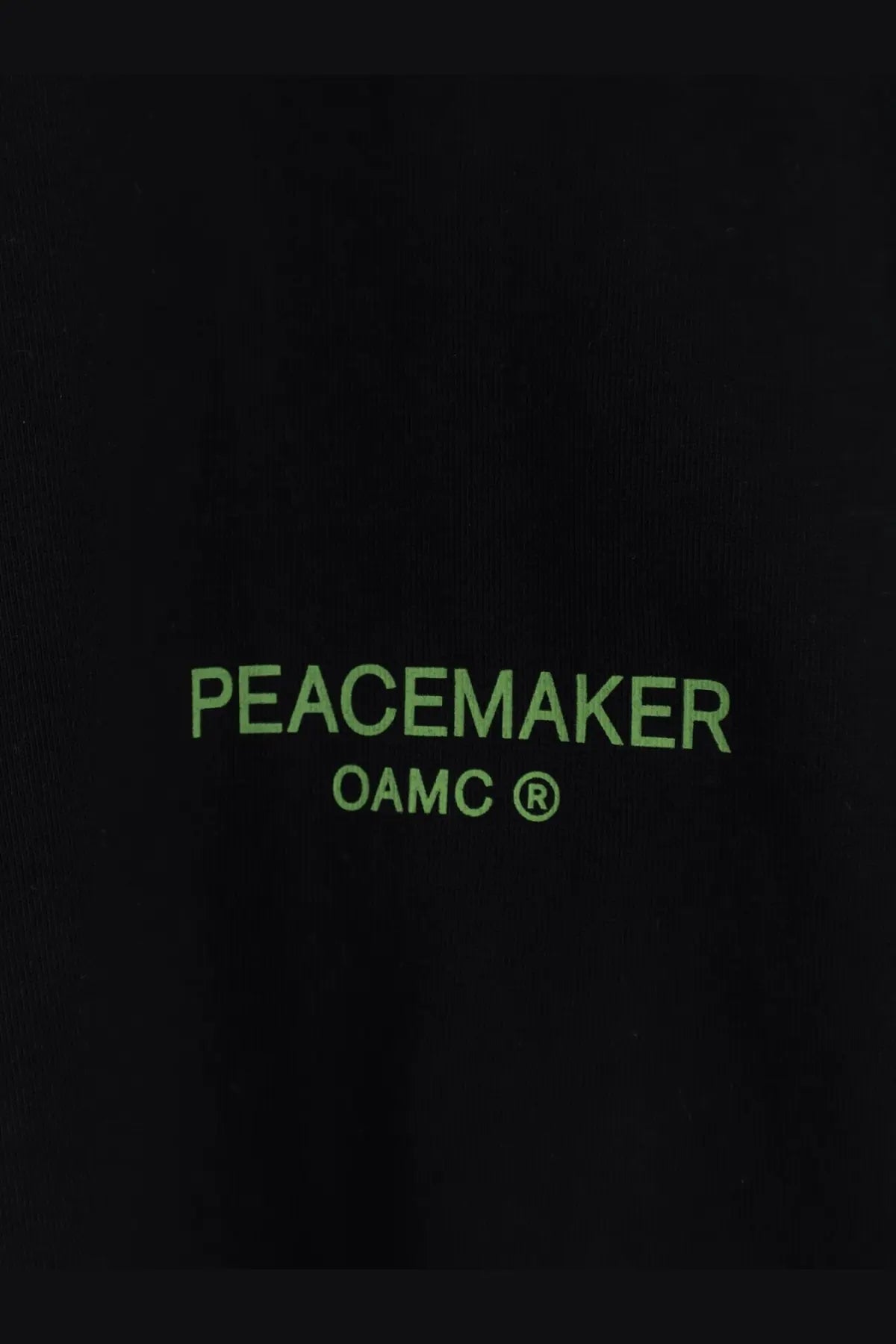Black oamc peacemaker men’s cotton sweatshirt with neon green peacemaker and oamc text on black fabric