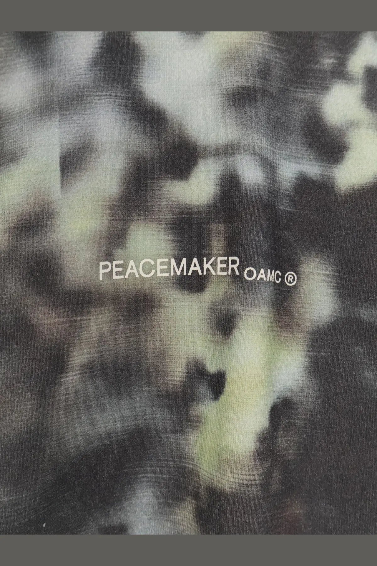 Black and pale green tie-dye oamc peacemaker men’s cotton sweatshirt with white text on the chest