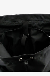 Black drawstring Oamc Peacemaker men’s jungle nylon backpack with reinforced stitching and metal eyelets