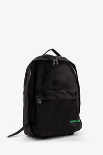 Oamc peacemaker men’s black nylon backpack with green peacemaker branding on the lower front side