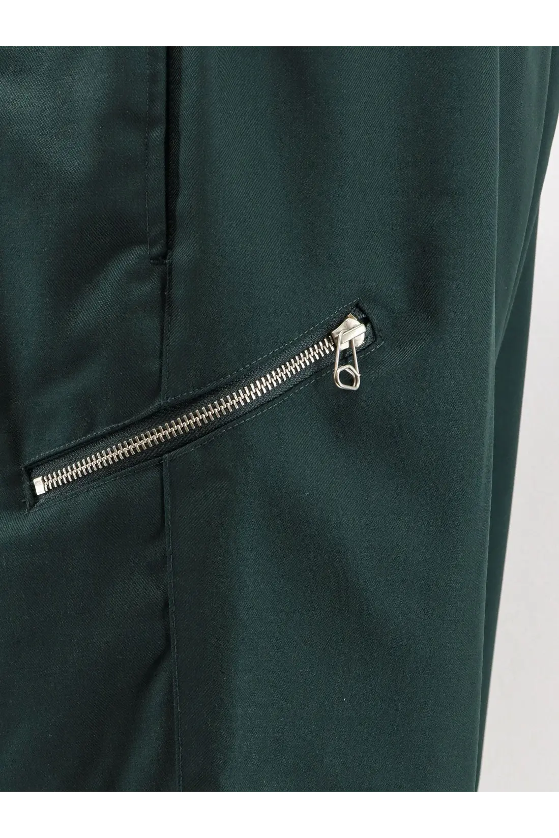 Dark green oamc peacemaker men’s virgin wool trousers with a sleek silver zipper and metallic pull tab