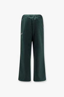 Dark green satin-like wide-leg pants with subtle logo on left thigh from oamc peacemaker virgin wool trousers