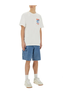 White cotton t-shirt with colorful graphic print on left chest paired with obey men’s baggy bigwig cargo shorts blue