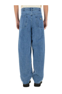 Back view of obey men’s bigwig baggy jeans in blue denim with a relaxed wide-leg cut and black logo patch on pocket