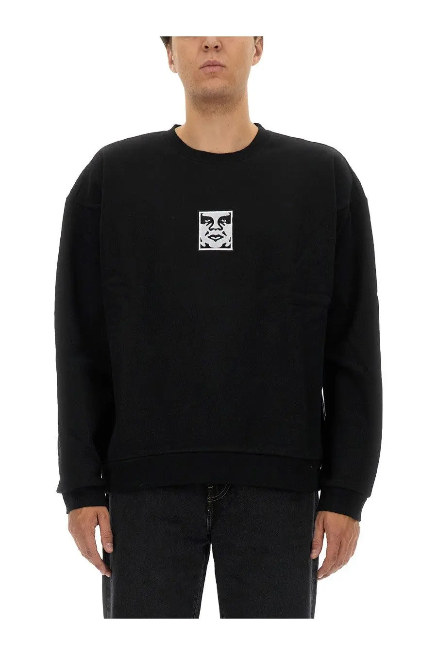 Obey men’s black cotton crewneck sweatshirt with a white embroidered face logo on the chest