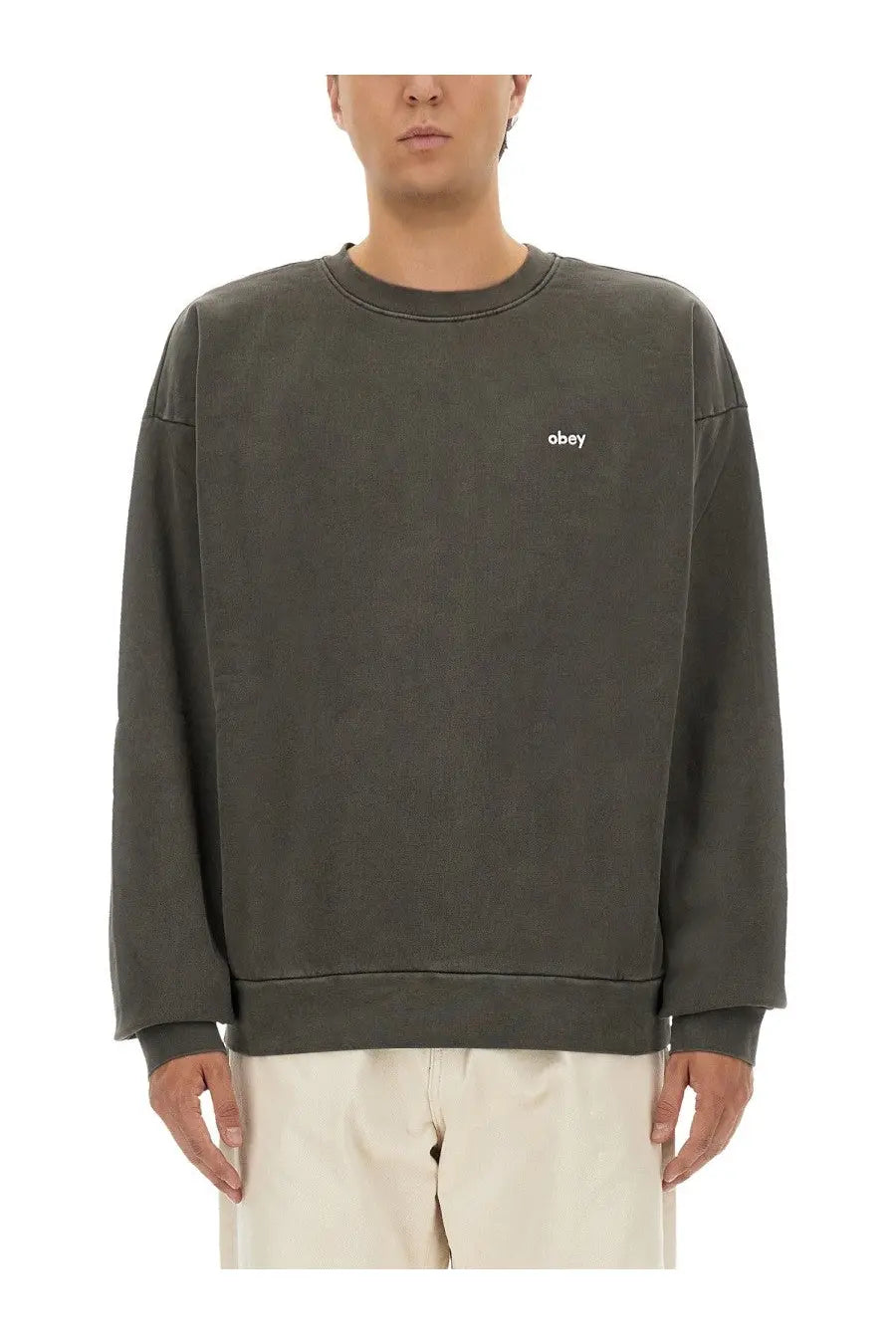 Obey men’s cotton sweatshirt in dark olive green with subtle faded texture and small white embroidered logo on chest