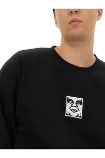 Obey men’s black cotton sweatshirt with white embroidered face logo on the chest