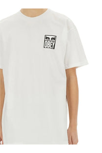 White cotton obey men’s eyes icon shirt with black rectangular logo and stylized eyes on front side