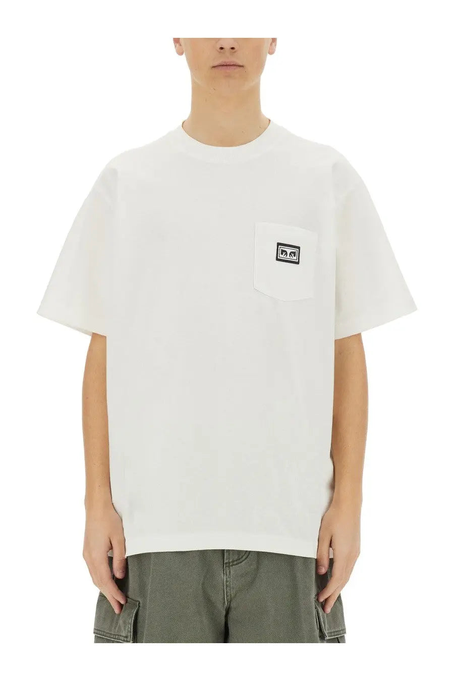 White obey men’s crewneck t-shirt with a small black and white logo patch on the left chest pocket