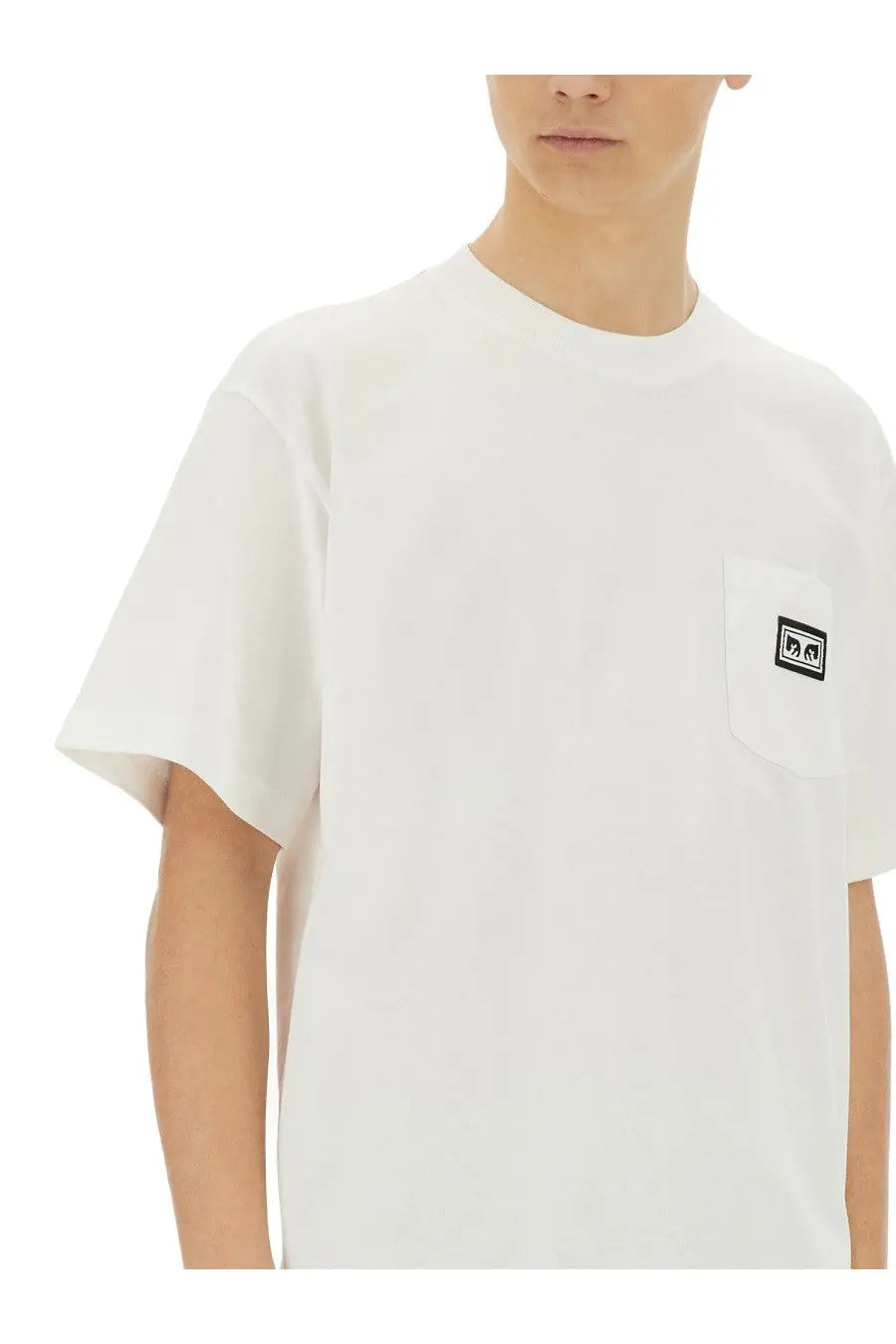 Obey men’s white short-sleeved cotton t-shirt with small black logo patch on left chest pocket
