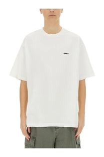 Obey men’s icon face white crewneck t-shirt with small black logo on left chest in cotton material