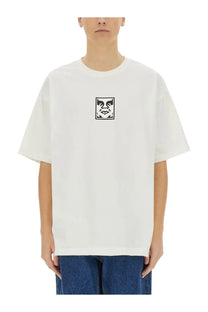 White oversized cotton t-shirt featuring a black square logo with an iconic face design from Obey men’s collection