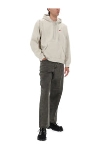 Beige hooded sweatshirt with small red logo on chest paired with obey men’s wrinkle grey pants