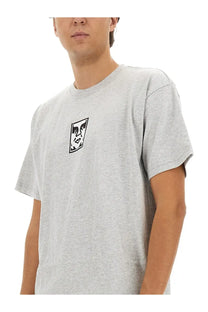 Obey men’s gray heathered cotton t-shirt with a black and white stylized face graphic on the left chest