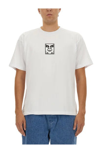 Obey men’s white short-sleeved cotton t-shirt with black rectangular graphic of a stylized face on the chest
