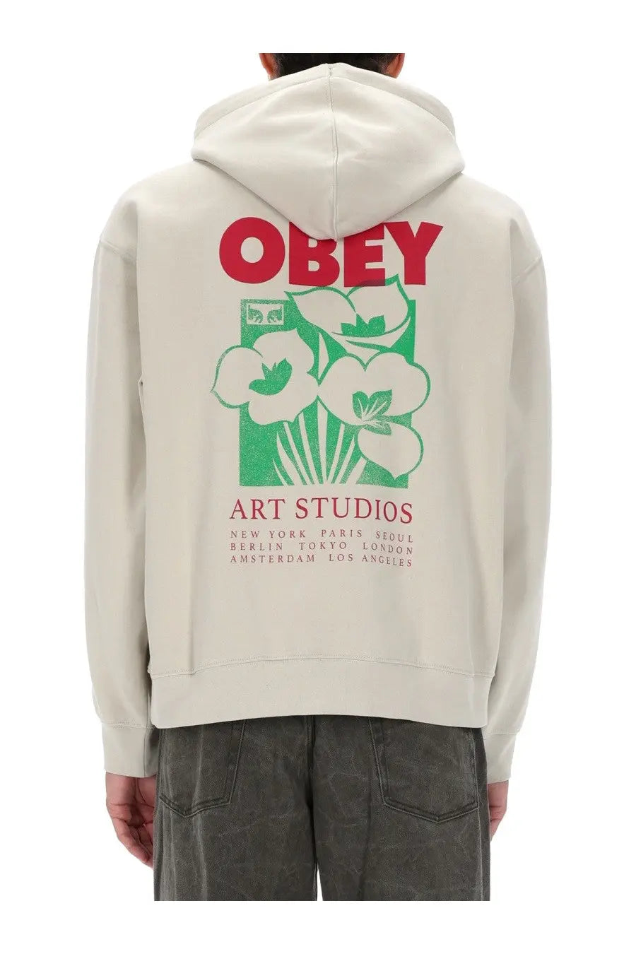 Obey men’s beige cream-colored hoodie with bold red and green floral graphic and art studios text on front