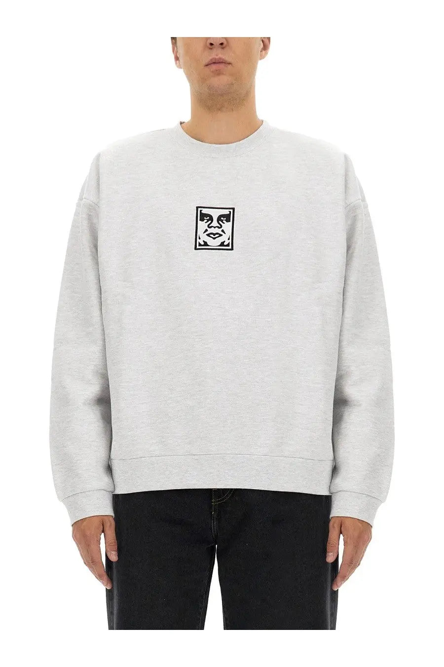 Obey men’s light gray crewneck sweatshirt with black and white stylized face graphic on chest
