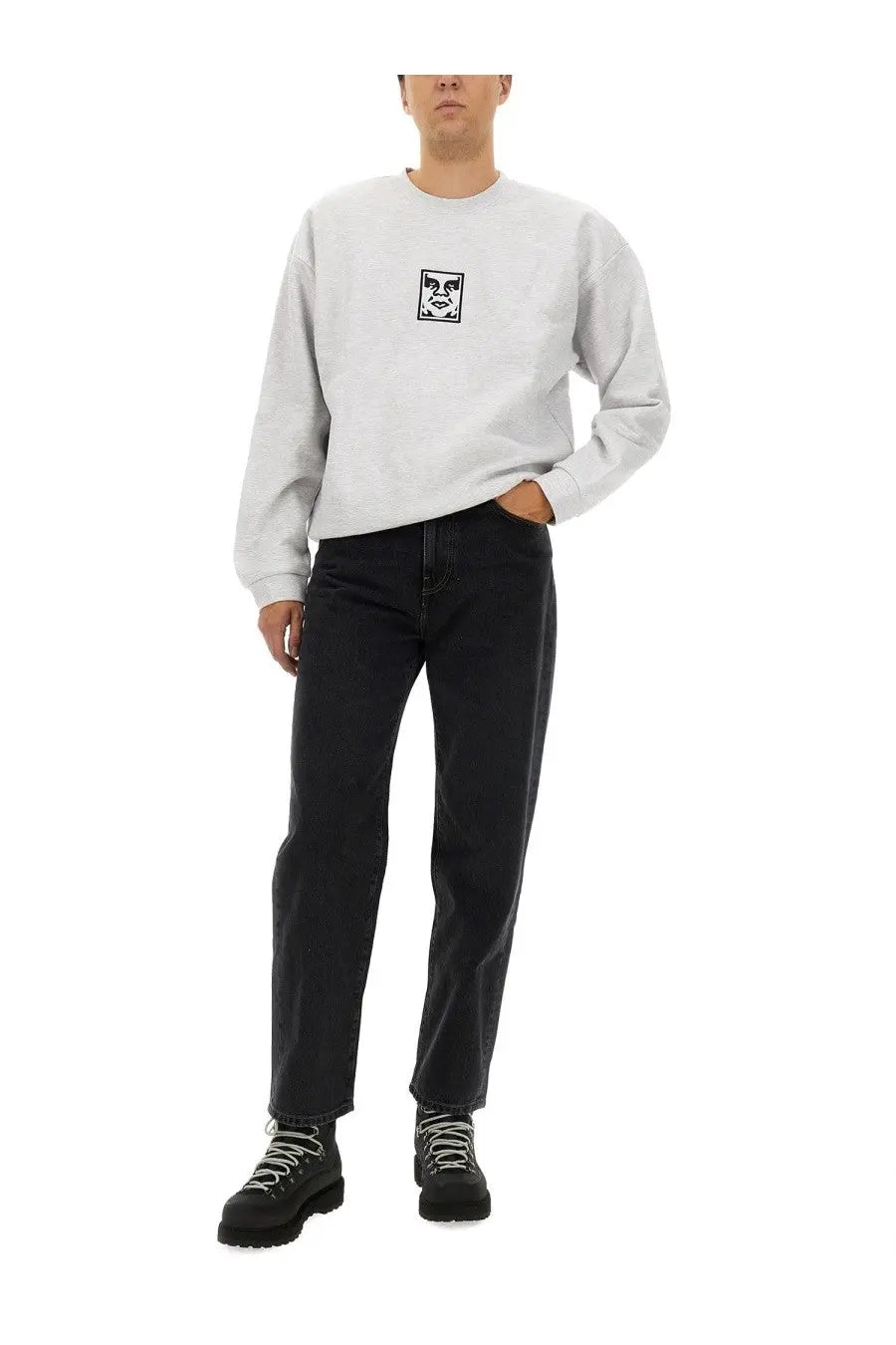 Obey men’s light gray long-sleeved sweatshirt with small black and white expressive face graphic on chest