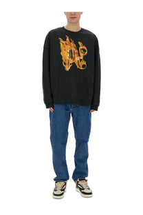 Palm angels men’s black long-sleeved sweatshirt with bold fiery orange and yellow flame design across the chest