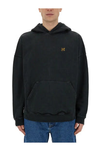 Black oversized Palm Angels men’s sweatshirt with gold embroidered burning monogram logo on the chest