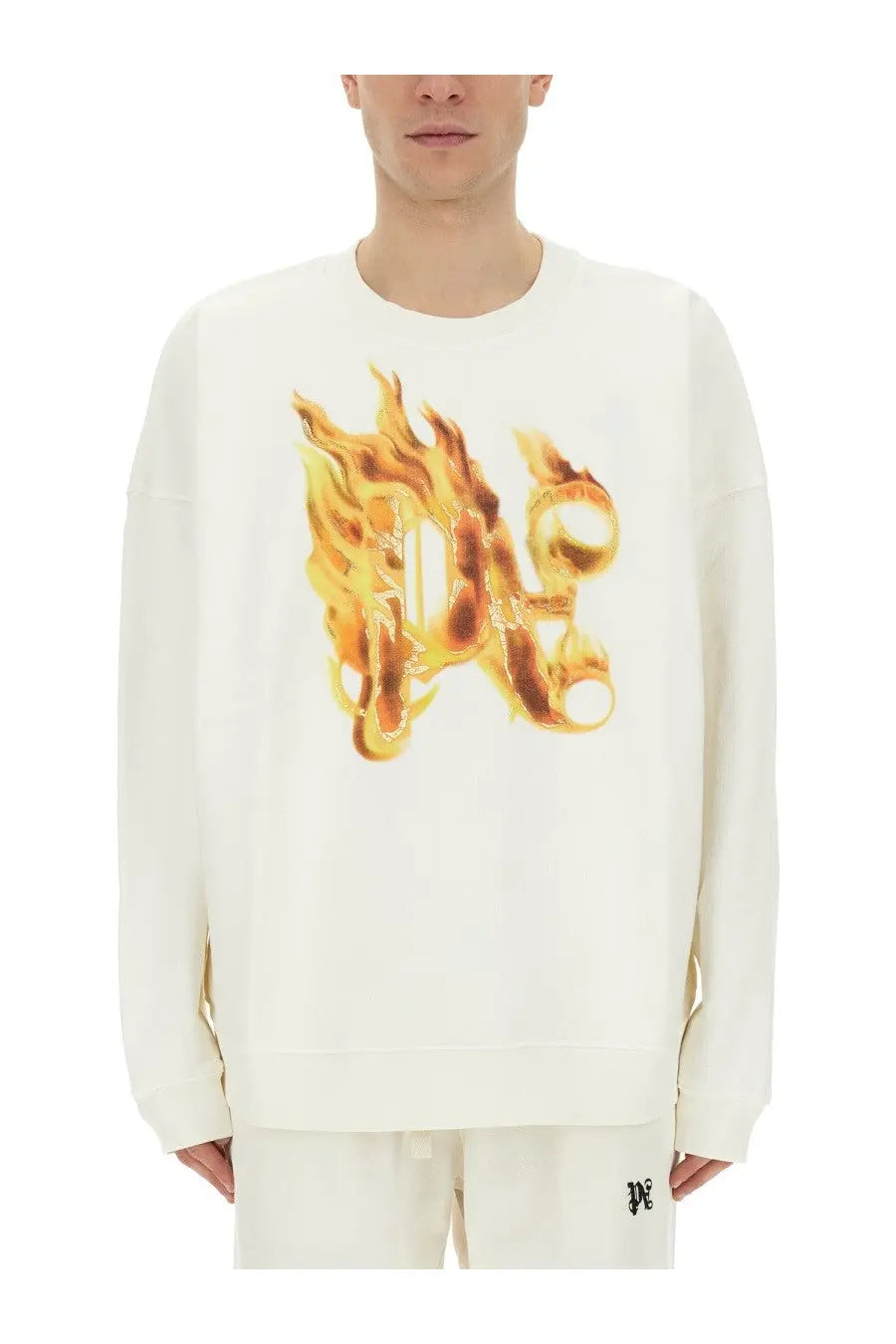 Off-white long-sleeved sweatshirt with bold orange and yellow flame graphic across chest by palm angels