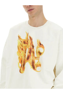 Palm Angels men’s white cotton sweatshirt with long sleeves and fiery orange and yellow flame design on the chest
